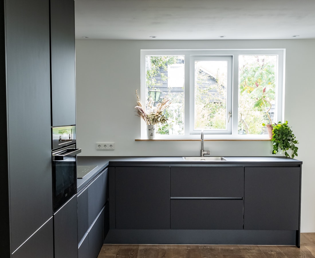 A contemporary charcoal kitchen with an open-plan layout