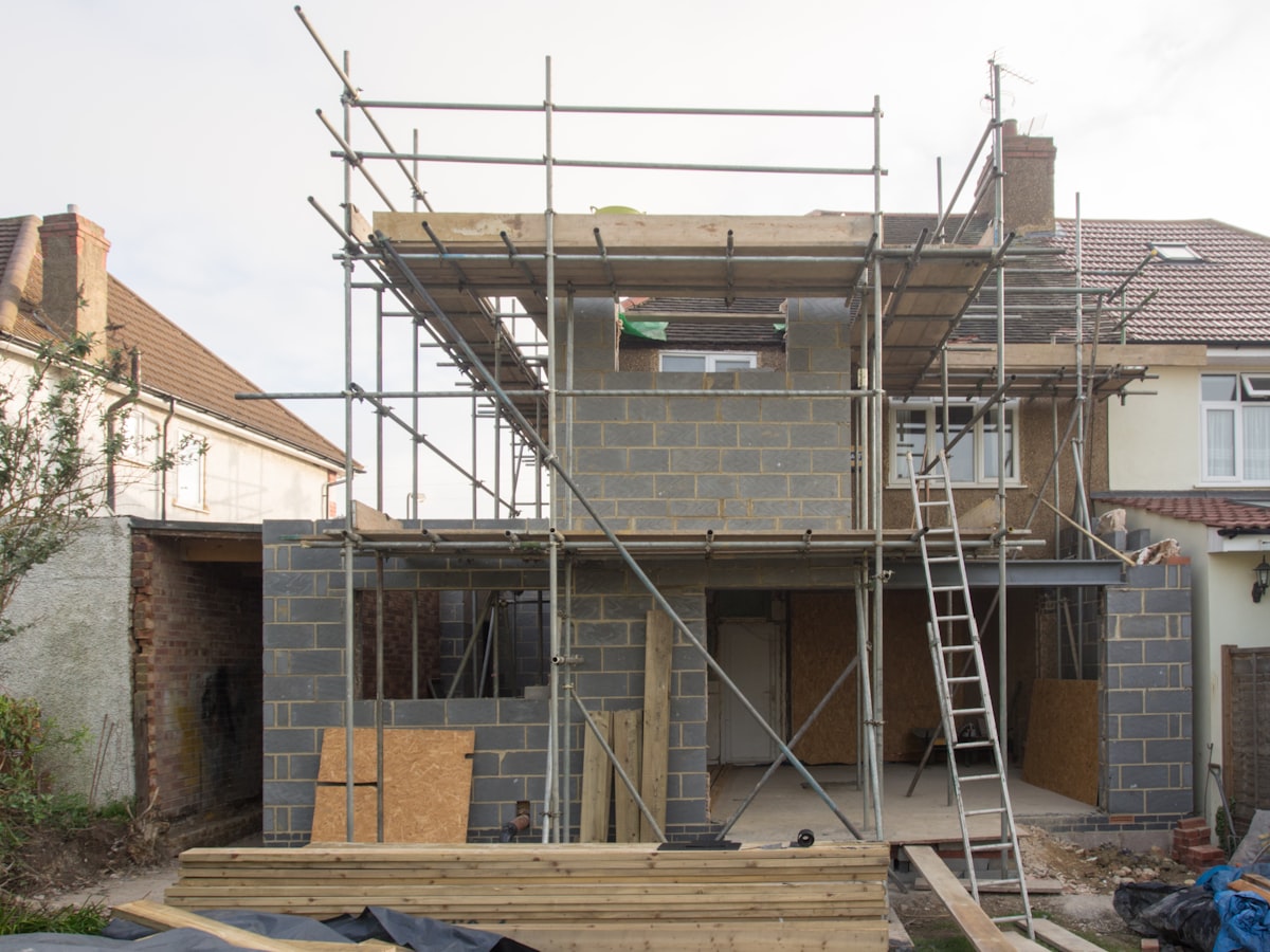 A house extension being built — new masonry and scaffolding on site