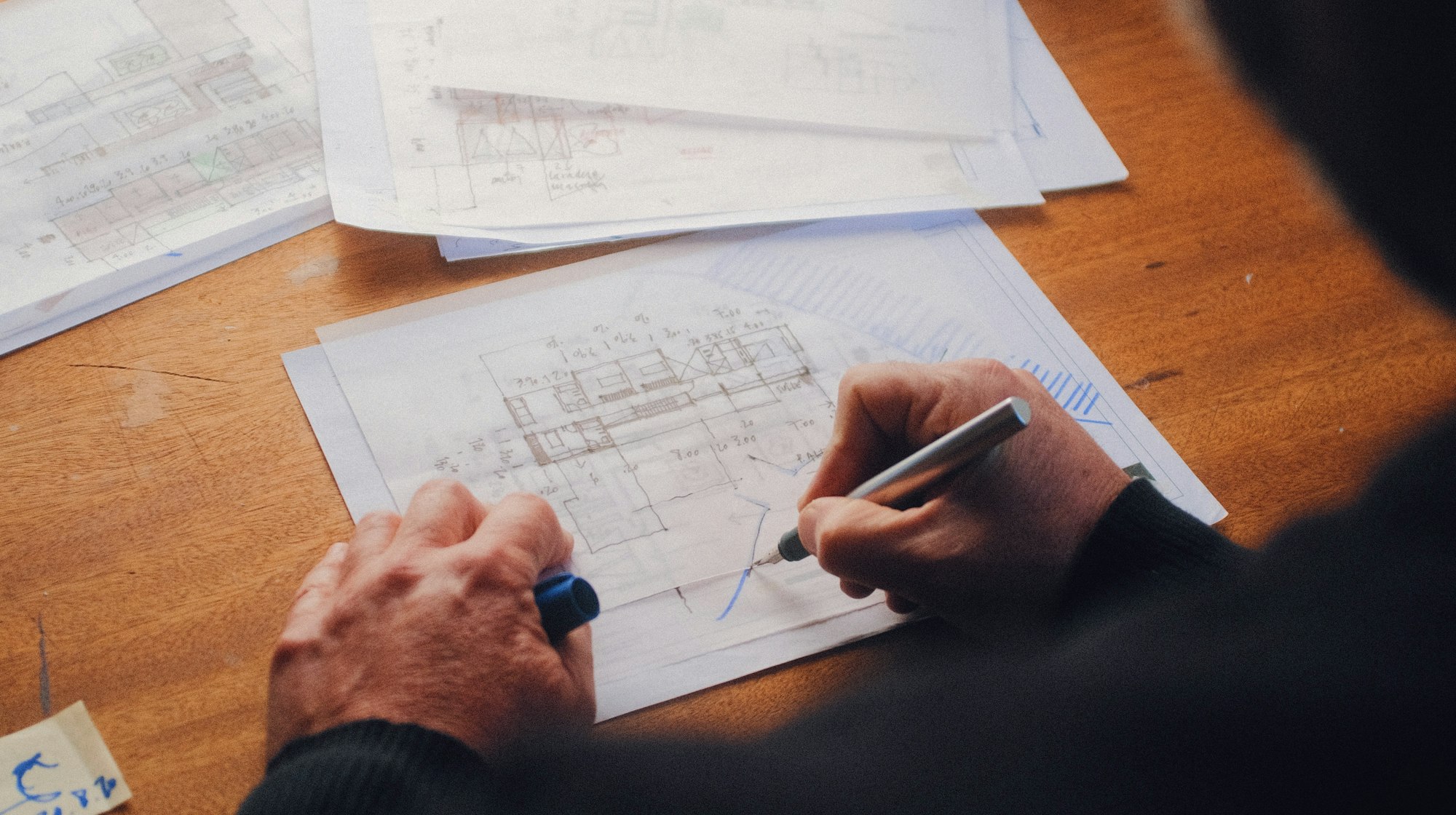 A desk with drawings and notes